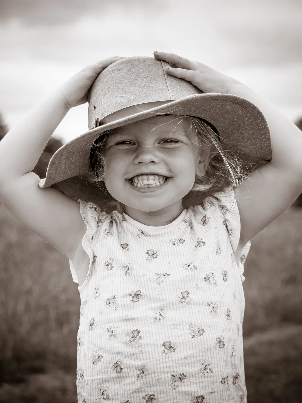 Girl wearing a man-sized hat